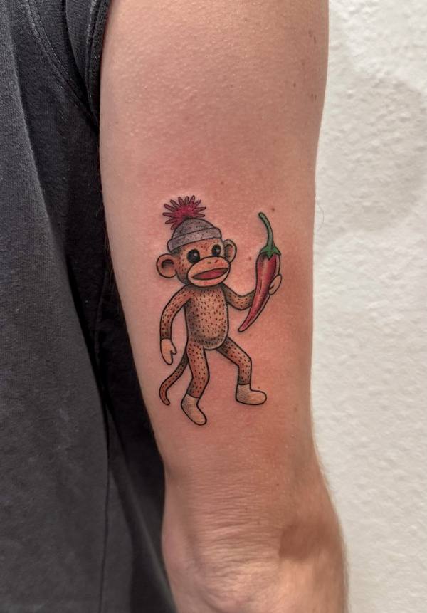 Illustrative color sock monkey tattoo by Cihan Pohrenk in Venice, Los Angeles