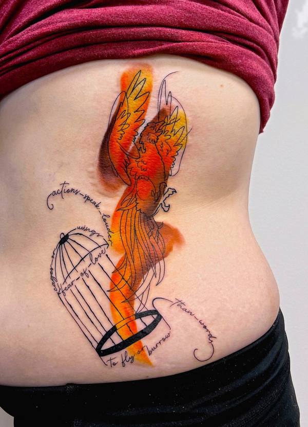 Watercolor phoenix tattoo with a birdcage and script by Cihan Pohrenk in Venice, Los Angeles