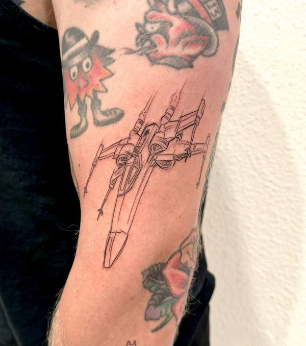 Illustrative X-wing starfighter outline tattoo by Cihan Pohrenk