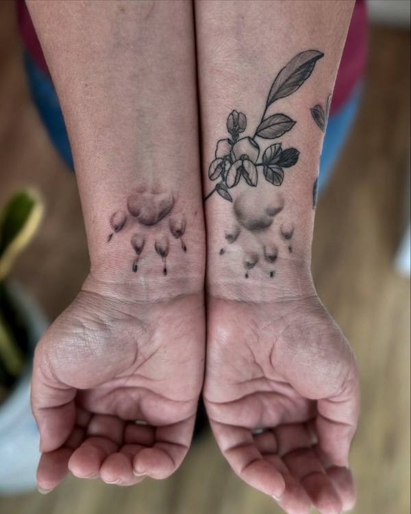 Fine line matching paw print tattoos by Cihan Pohrenk in Venice, Los Angeles