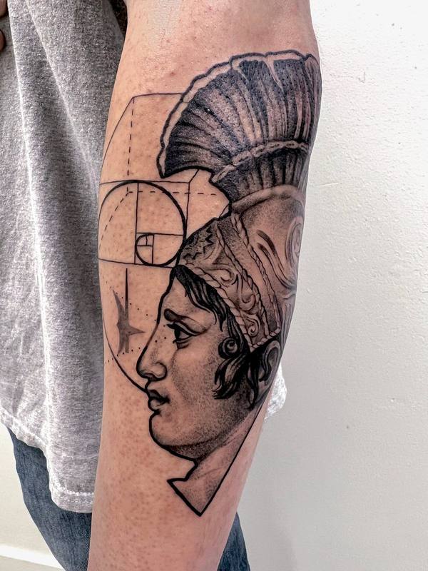Black and gray realism Roman helmet profile tattoo by Cihan Pohrenk