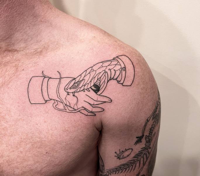 Hand holding snake fine line shoulder tattoo by Cihan Pohrenk in Venice, Los Angeles