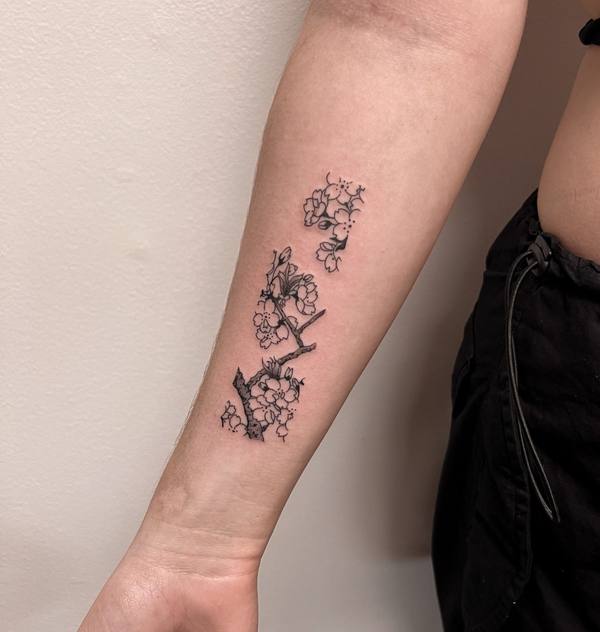 Cherry blossom branch fine line forearm tattoo by Cihan Pohrenk in Venice, Los Angeles