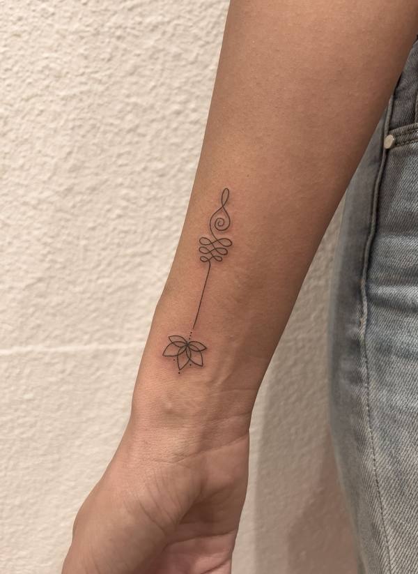 Treble clef, infinity and lotus fine line forearm tattoo by Cihan Pohrenk in Venice, Los Angeles