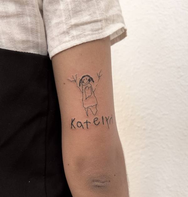 Child's drawing style portrait and name fine line arm tattoo by Cihan Pohrenk