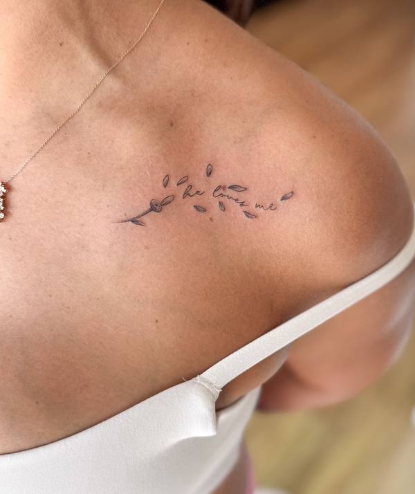 He Loves Me script with flower fine line shoulder tattoo by Cihan Pohrenk in Venice, Los Angeles
