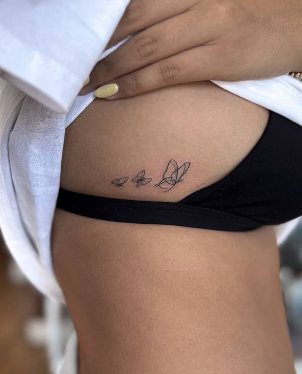 Three butterflies fine line hip tattoo by Cihan Pohrenk in Venice, Los Angeles