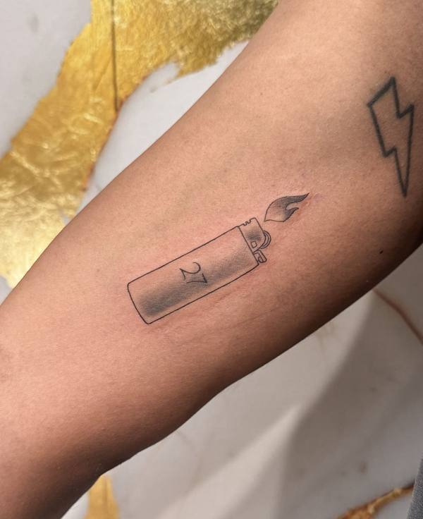 Lighter with flame fine line forearm tattoo by Cihan Pohrenk in Venice, Los Angeles