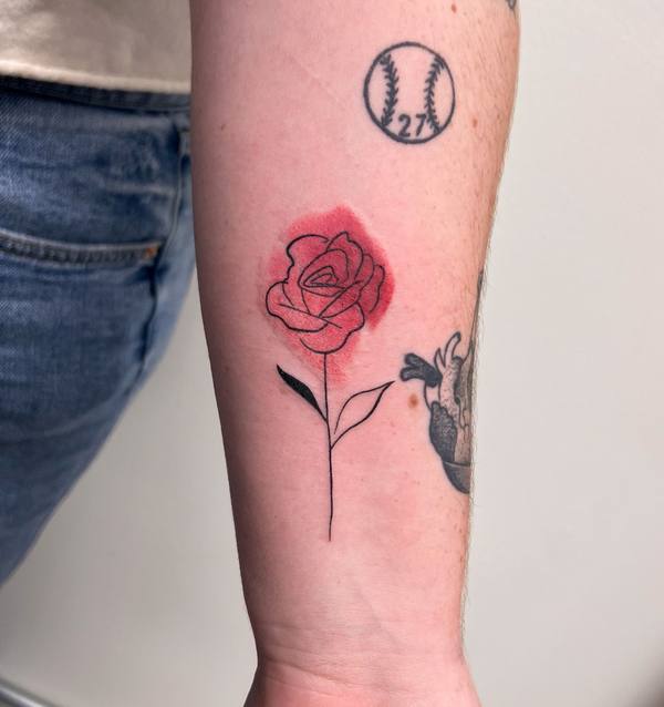 Rose with watercolor wash and baseball color forearm tattoo by Cihan Pohrenk in Venice, Los Angeles