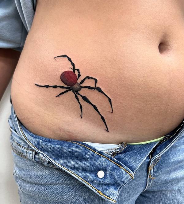 Black widow spider color abdomen tattoo by Cihan Pohrenk in Venice, Los Angeles